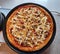 Big round appetizing pizza with cheese and sausages