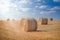 Big round bales on the field at sunset