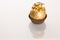 Big round chocolate candy wrapped in golden foil with big bow on