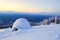 Big round igloo stands on mountains.
