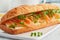Big sandwiche with salmon, cream cheese, cucumber slices on white concrete table.