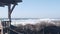 Big sea wave crashing, rocky craggy beach, California ocean coast, gazebo alcove