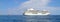 big seagoing passenger ship in the sea and next to it a small boat  blue sea and blue sky
