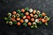Big set of pieces of sushi rolls on black stone background. Top view.