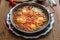 Big shakshuka in iron pan, close view.