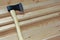 Big sharp ax with black blade and light yellow handle on fresh wooden boards.