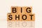 Big shot text on light wooden blocks, investment profit with stock market, no people