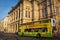 Big sightseeing touristic bus and facade of Vienna Opera House