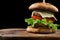 Big single cheeseburger isolated on black background