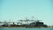 Big sky shot of cranes loading trailers into a huge cargo ship in Oaklands docks