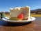 Big slice of cheesecake with country background