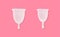 Big and small size menstrual cups on pink background