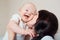 Big smile toddler. Mom hugging baby. Kid laughing in the arms of