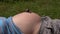 Big snail crawl on pregnant woman belly