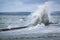 Big splash of wave on the flooded embankment of the resort city on the Black Sea