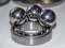 Big stainless balls on a top of a ball bearing with reflections of it