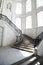 Big staircase with openwork metal curved banister inside