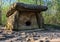 Big stone Pshada dolmen in summer Caucasus mountain forest on sunny day. Ancient megalithic tomb with large flat stone slabs and