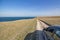 Big stones calm sea, clear sky with clouds skyline and road