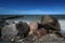 Big stones and small waves on the coast at the Baltic Sea, dark blue sky with copy space, long term exposure