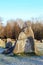 The big stones standing in the snow field in winter