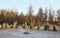 The big stones standing in the snow field in winter