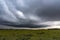 big storm over a little lagoon covered with water plants and dark sky in San Vicente, Buenos Aires