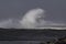 Big stormy sea wave splash with wind spray