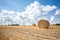 Big straw bale on field in summer-horizontal.