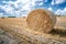 Big straw bale on field in summer-horizontal.