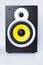 Big subwoofer with yellow speaker on white background,loud music