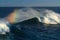 Big surf wave breaking, with rainbow colours