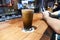 A big tall glass of frothy delicious beer at a bar