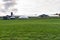 Big tanks for biogas production in front of a large barn