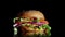 Big and tasty burger is rotating on the plate. Isolated footage