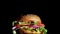 Big and tasty burger is rotating on the plate. Isolated footage