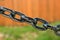 big thick steel dark metal chain links foreground closeup outside