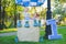 Big toy balloon in city park. Candy-table example. Birthday - one year old with figure number one. Mother and her son on grass.