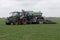 Big tractor injects liquid manure in a meadow