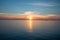 Big transporter ship during sunset on the ocean silhouette of boat