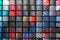 Big variety of different color neckties in a men clothing store