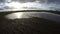 Big water puddle on young green wheat field, time lapse 4K