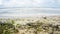 Big wave of blue ocean on sandy beach with plastic garbage and medical waste materials