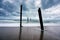 Big wave hitting a decay wooden bridge on the beach in stormy weather at Pilai beach, Phang nga