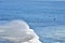 Big wave in the pacific ocean with people swimming in Punta de Lobos, Pichilemu, Chile