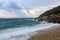 Big waves in the beach and rocks in stormy weather