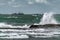Big waves breaking coastal rocks