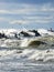 Big waves breaking over harbor breakwall concrete tetrapods