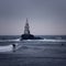 Big waves crashing at lighthouse.