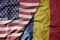 big waving colorful flag of united states of america and national flag of romania